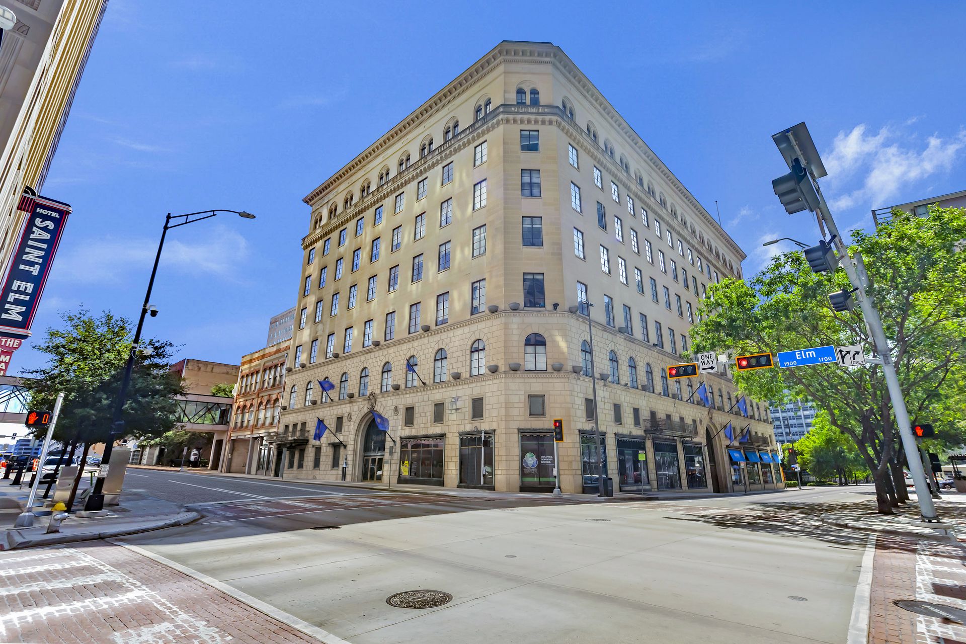 The 1900 Elm building at the corner of Elm and St. Paul with trees along the sidewalk