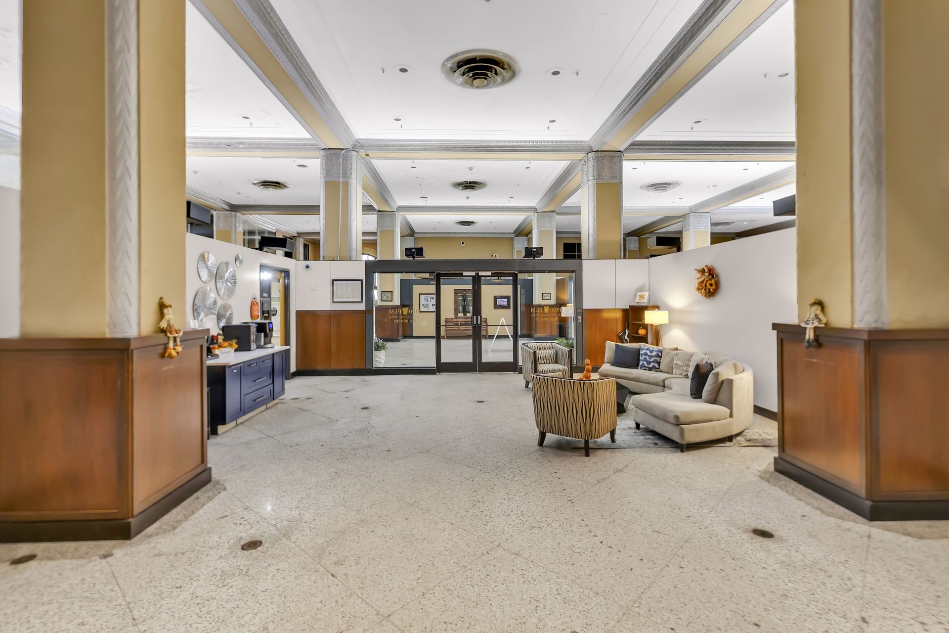 Terrazzo lobby with square columns and lounge seating at 1900 Elm Lofts